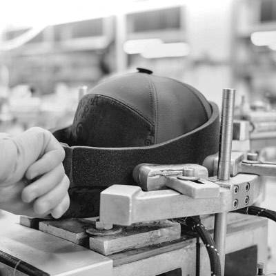 A cap held on the head of an embroidery machine