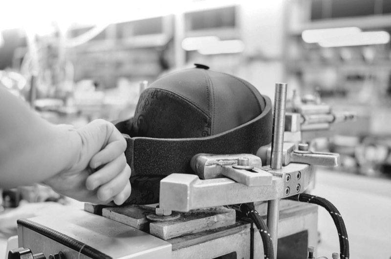 A cap held on the head of an embroidery machine