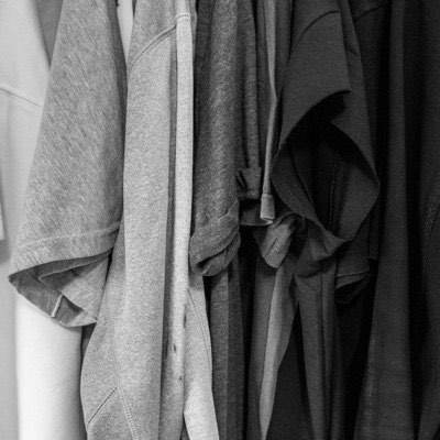 Plain grey t-shirts hanging together on a rail