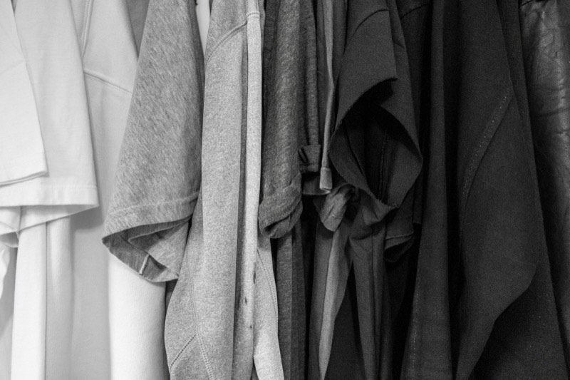 Plain grey t-shirts hanging together on a rail