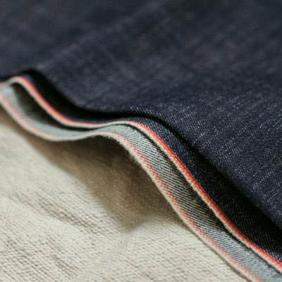 Folded selvedge denim showing the red and white selvedge edge
