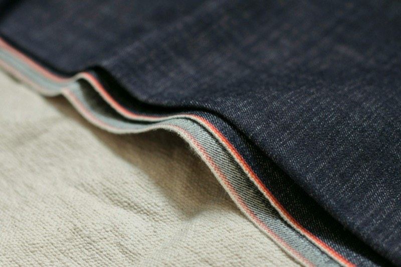 Folded selvedge denim showing the red and white selvedge edge