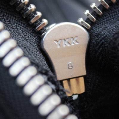Close-up of a YKK branded zipper pull on a knitted garment