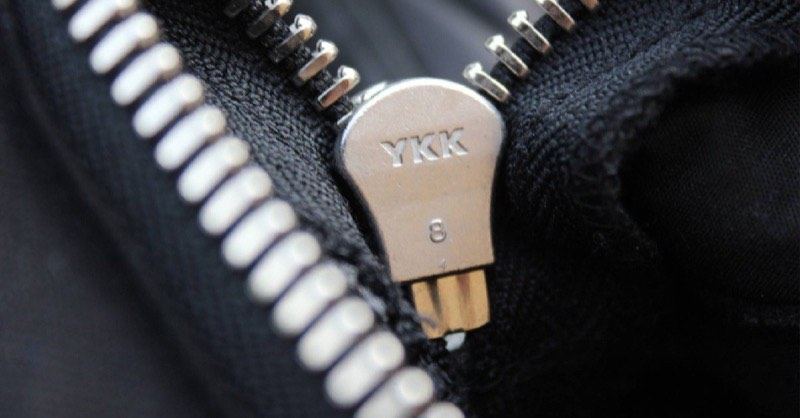 Close-up of a YKK branded zipper pull on a knitted garment